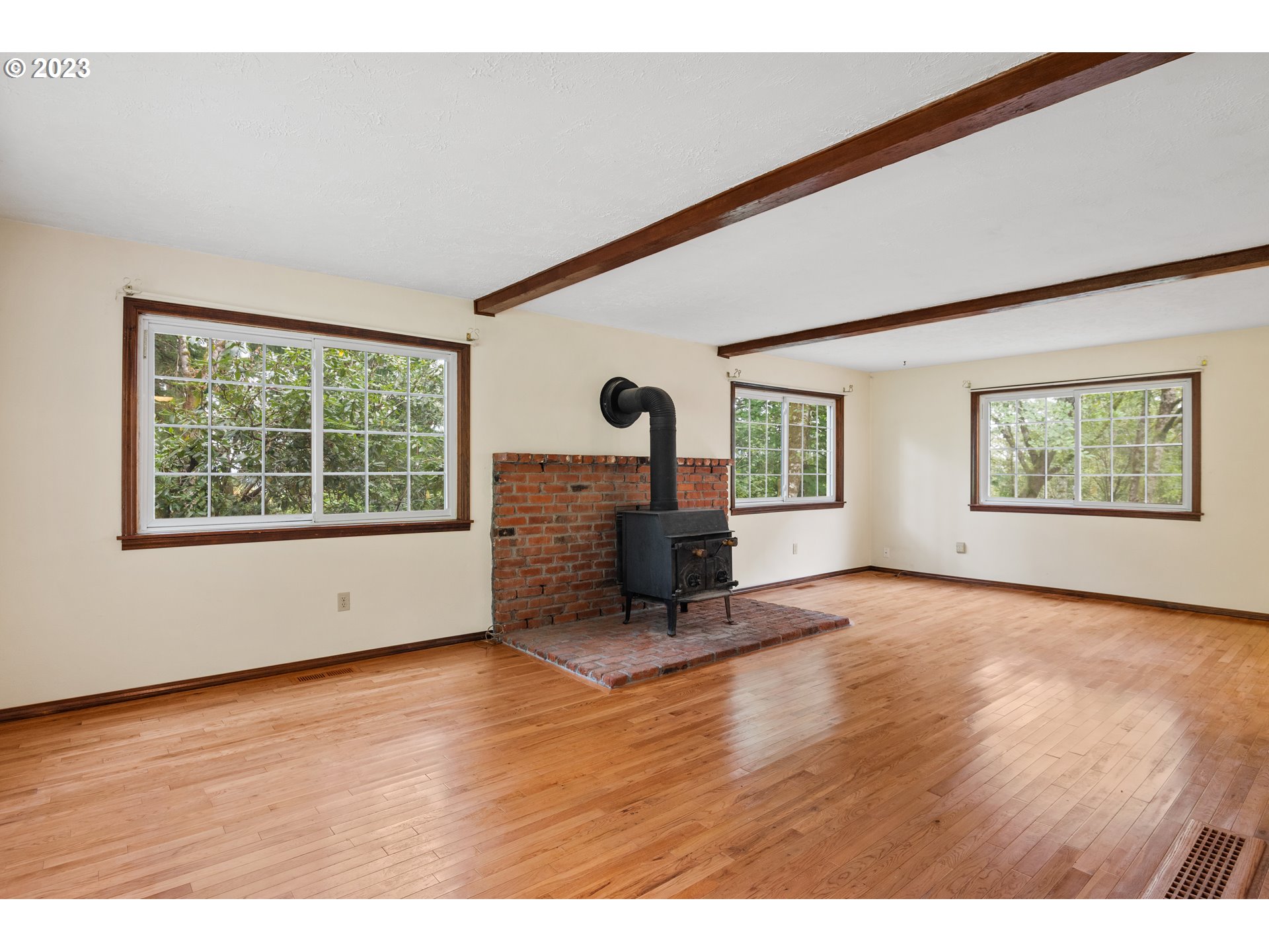 234 Walker Road Kelso, WA 98626 - Photo 9 of 35 a view of an empty room with a window and wooden floor