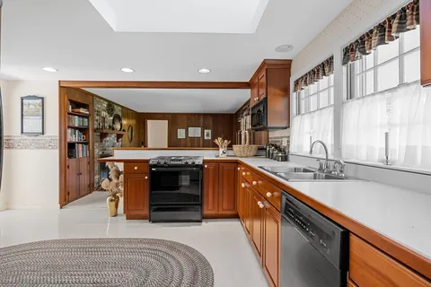 a kitchen with stainless steel appliances granite countertop a sink and cabinets