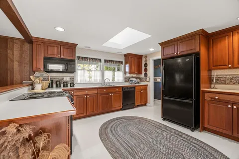 a kitchen with stainless steel appliances granite countertop a refrigerator stove and oven