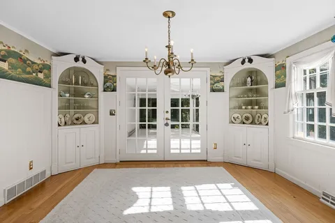 a view of a room with wooden floor and windows