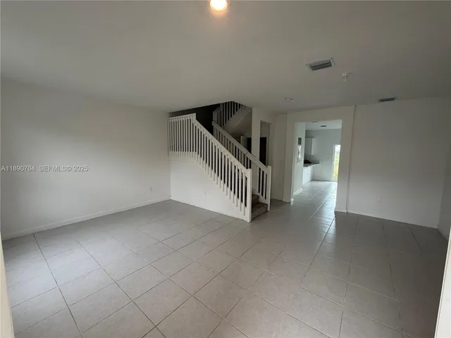 a view of an empty room with stairs