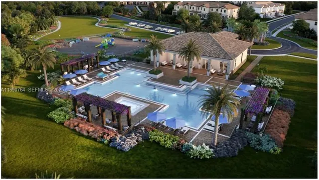 an aerial view of a house with garden space and lake view