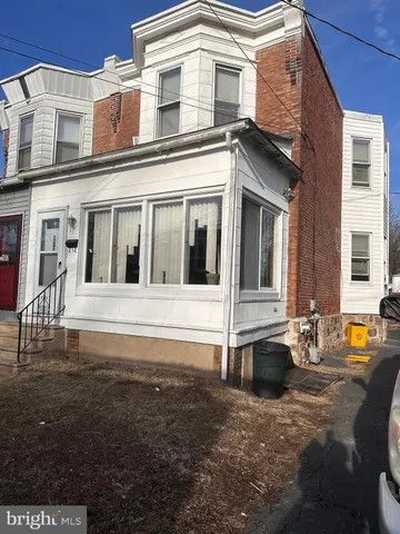 a front view of a house with outdoor seating