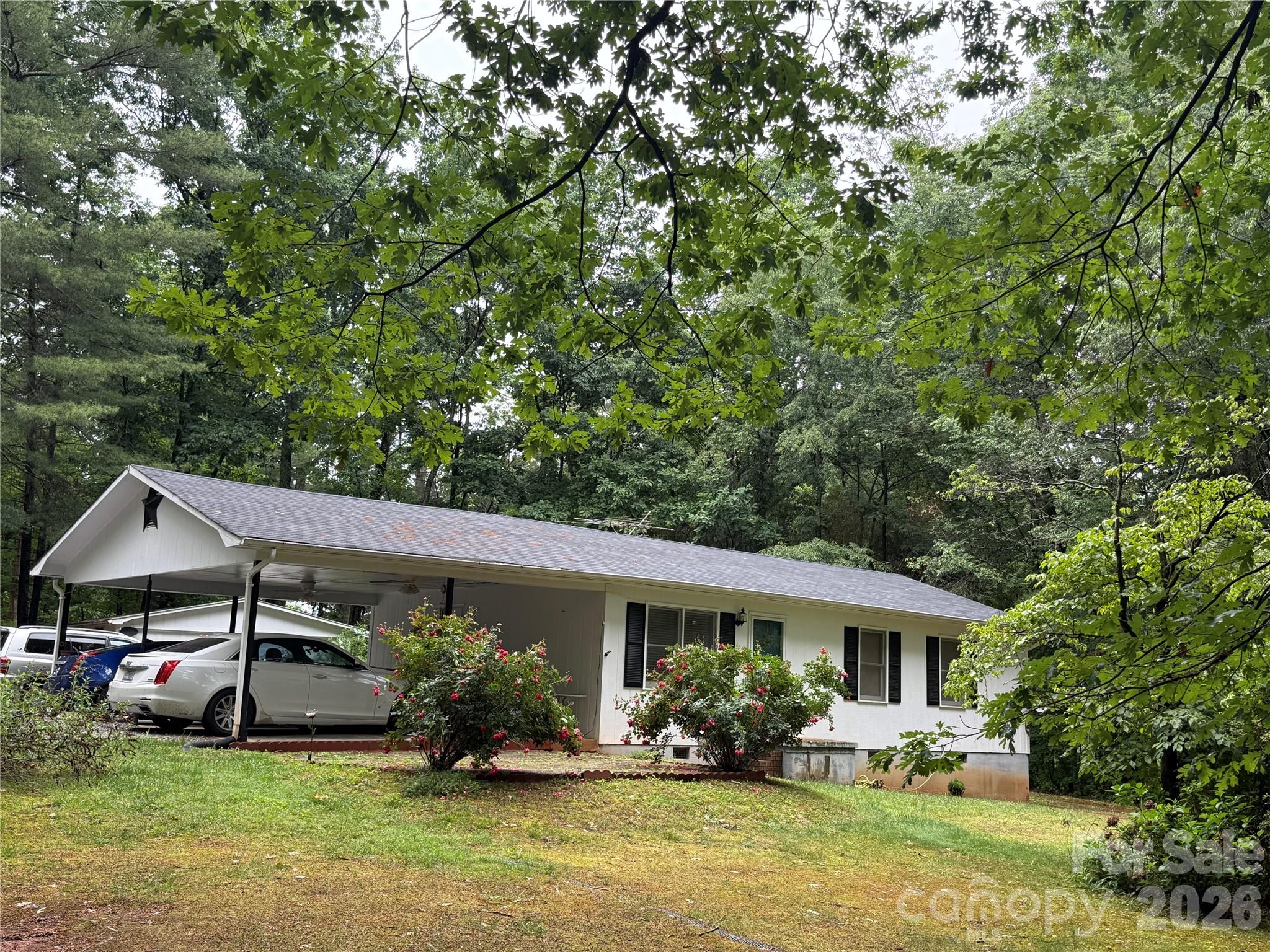 580 Legion Road Lenoir, NC 28645 - Photo 16 of 22 a front view of a house with garden