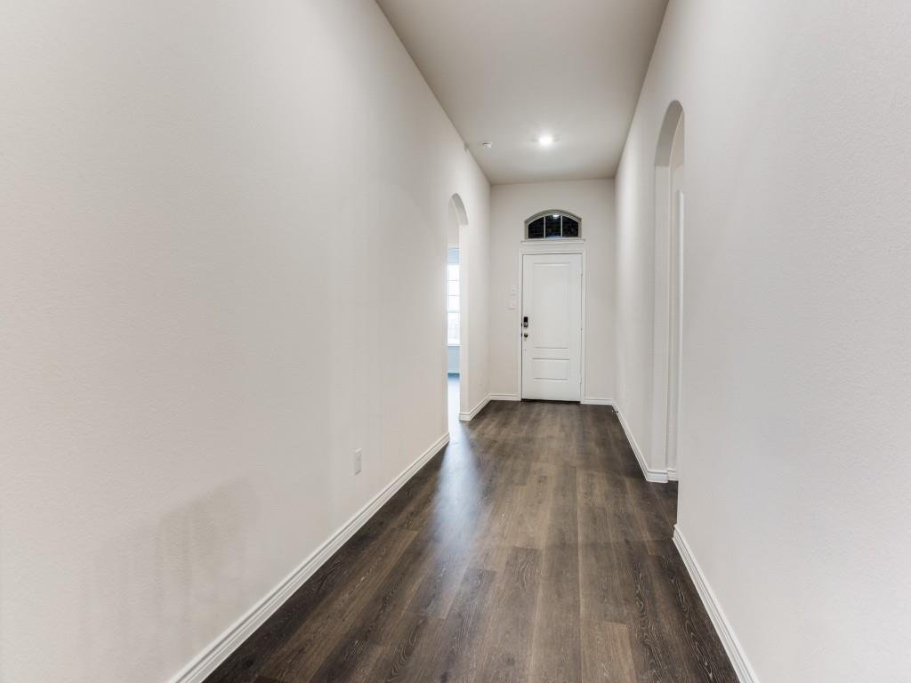 123 Lakeview Circle Pilot Point, TX 76258 - Photo 7 of 39 a view of a hallway with wooden floor