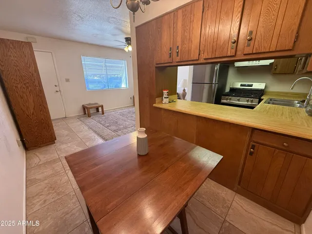 a kitchen with wooden cabinets and a sink