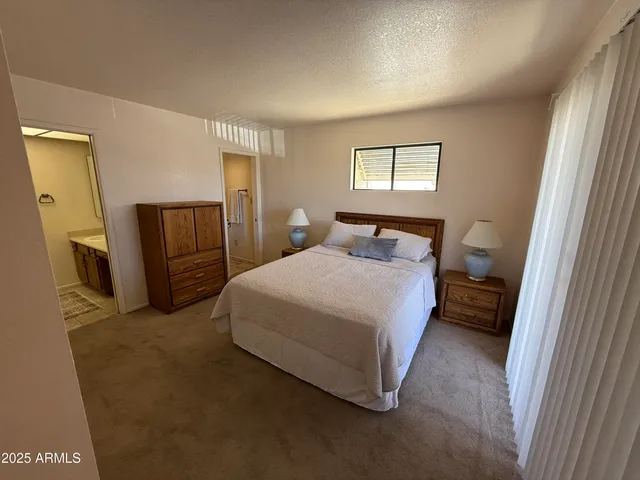 a bedroom with a bed closet and a window