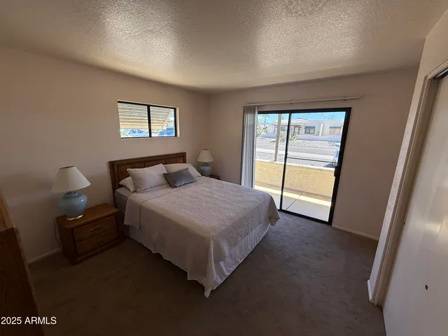 a spacious bedroom with a bed and a window