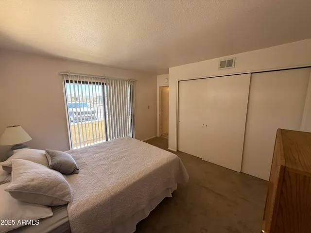 a bedroom with a bed and a window