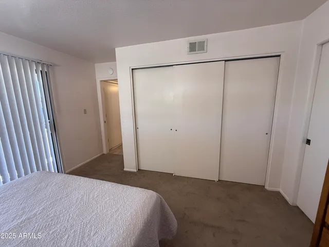 a bed room with a bed and a mirror