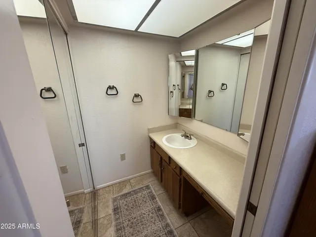 a bathroom with a sink and mirror
