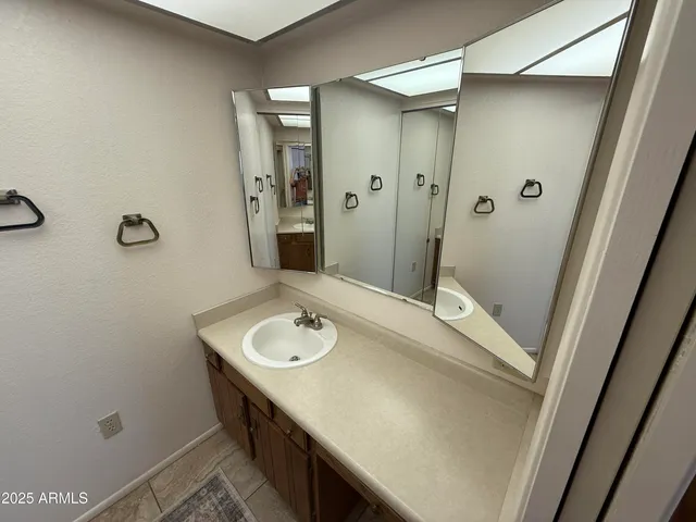 a bathroom with a sink a mirror and a toilet