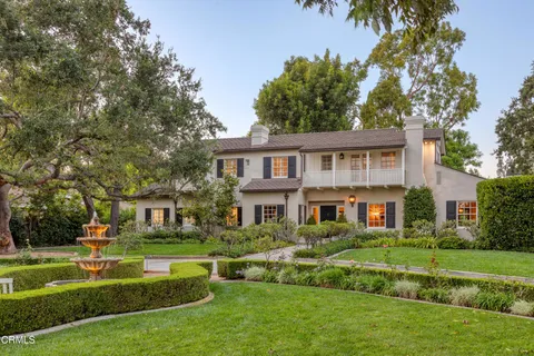 a front view of a house with a yard table and chairs