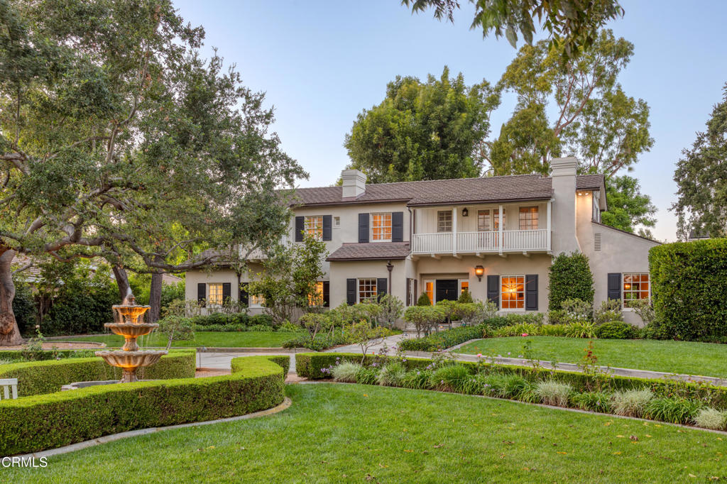 a front view of a house with a yard table and chairs