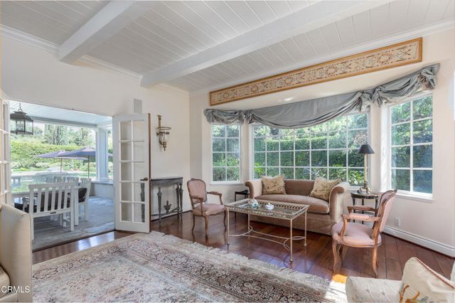 a dining room with furniture a chandelier and wooden floor
