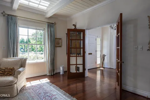 a kitchen with stainless steel appliances granite countertop a table chairs sink and cabinets