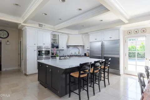 a kitchen with granite countertop a sink and dishwasher a stove top oven with wooden floor
