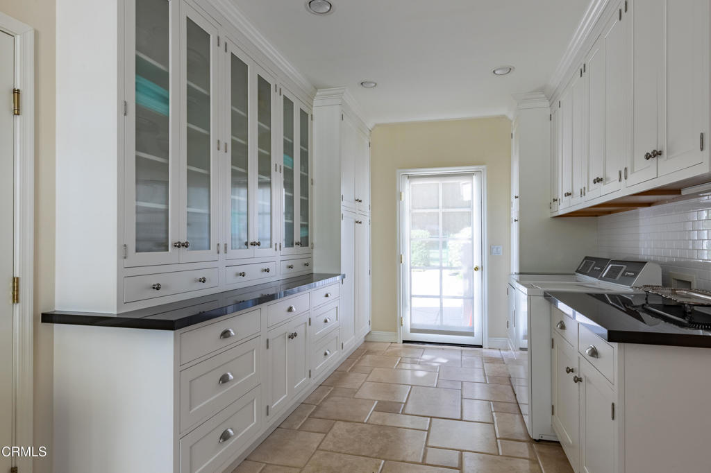 3121 Monterey Road San Marino, CA 91108 - Photo 32 of 77 a kitchen with granite countertop white cabinets and window