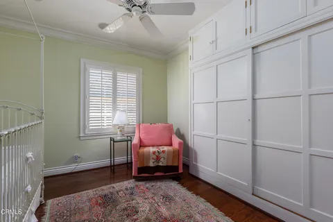 a living room with patio furniture and a large window