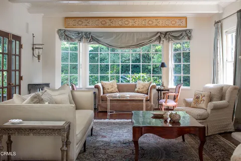 a living room with furniture wooden floor and a table