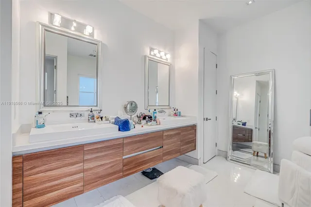 a bathroom with double sink and a mirror