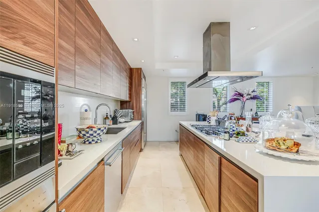 a kitchen with stainless steel appliances granite countertop a sink and stove