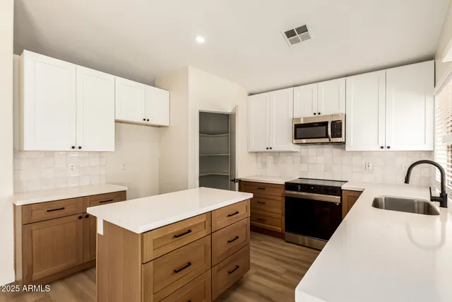 a kitchen with a sink a stove and refrigerator