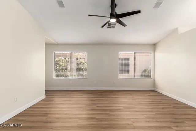 wooden floor in an empty room with a window