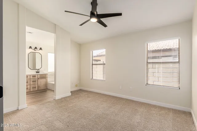 a view of empty room with ceiling fan
