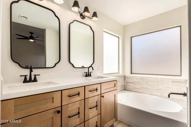 a bathroom with a double vanity sink and a mirror