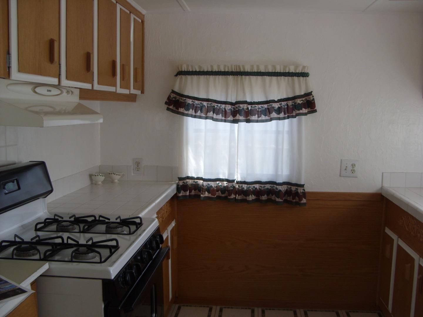 1117 Baldwin Street, Unit 74 Salinas, CA 93906 - Photo 6 of 13 a kitchen with a sink a stove and a window