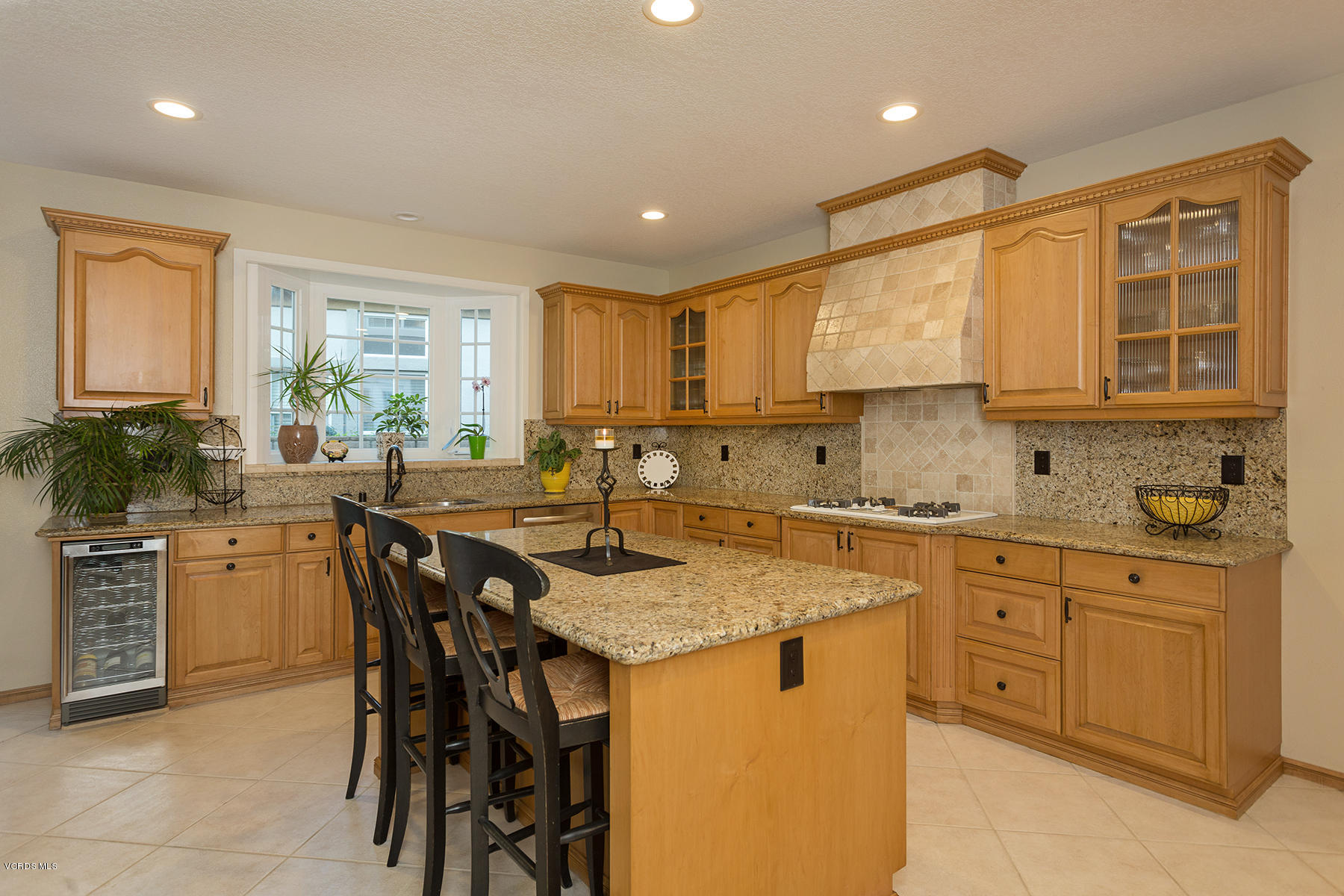 203 Knoll Ridge Road Simi Valley, CA 93065 - Photo 15 of 53 a kitchen with stainless steel appliances granite countertop wooden cabinets a sink a stove a dining table and chairs