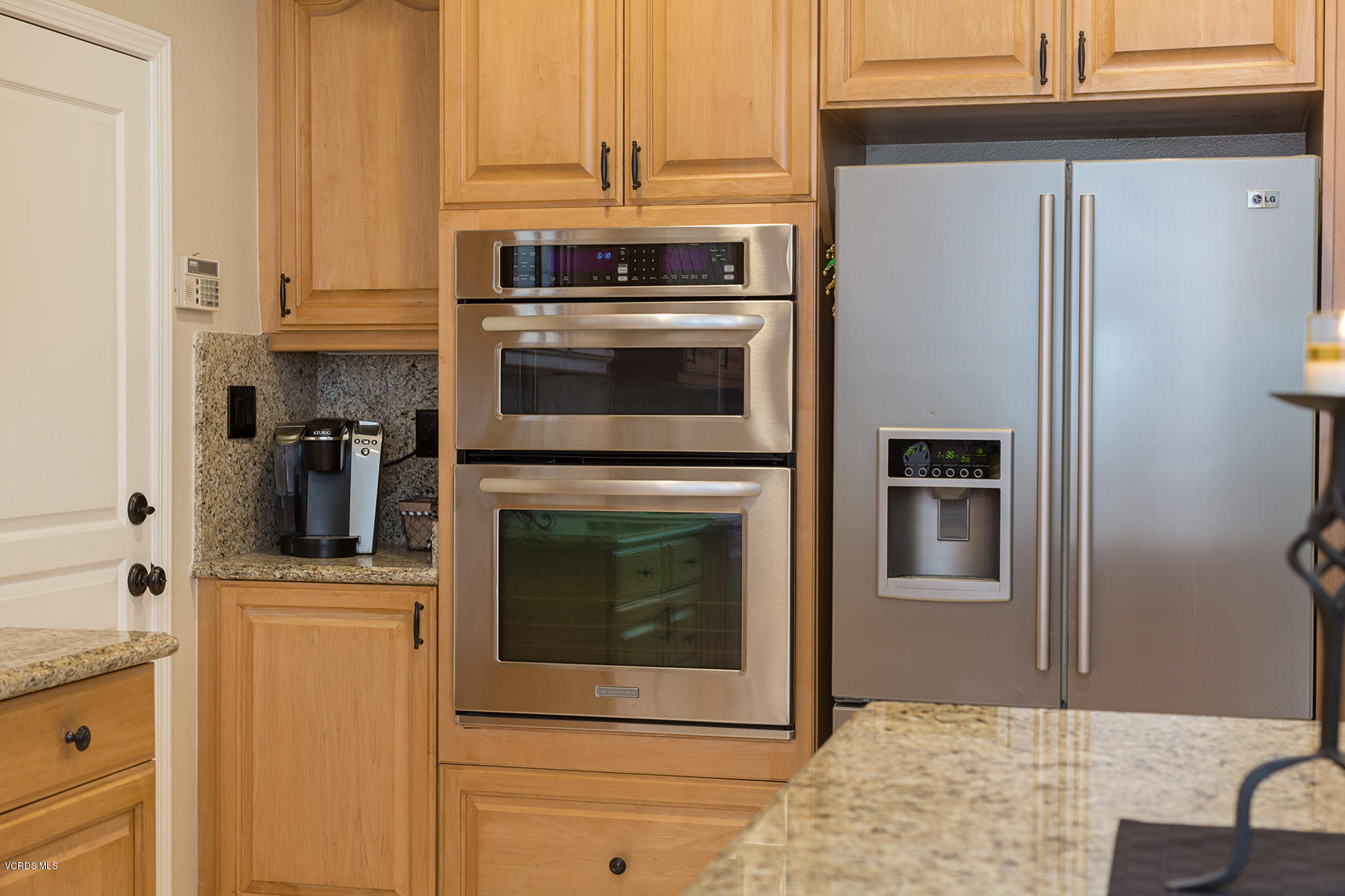 203 Knoll Ridge Road Simi Valley, CA 93065 - Photo 17 of 53 a kitchen with granite countertop a stove top oven and cabinets
