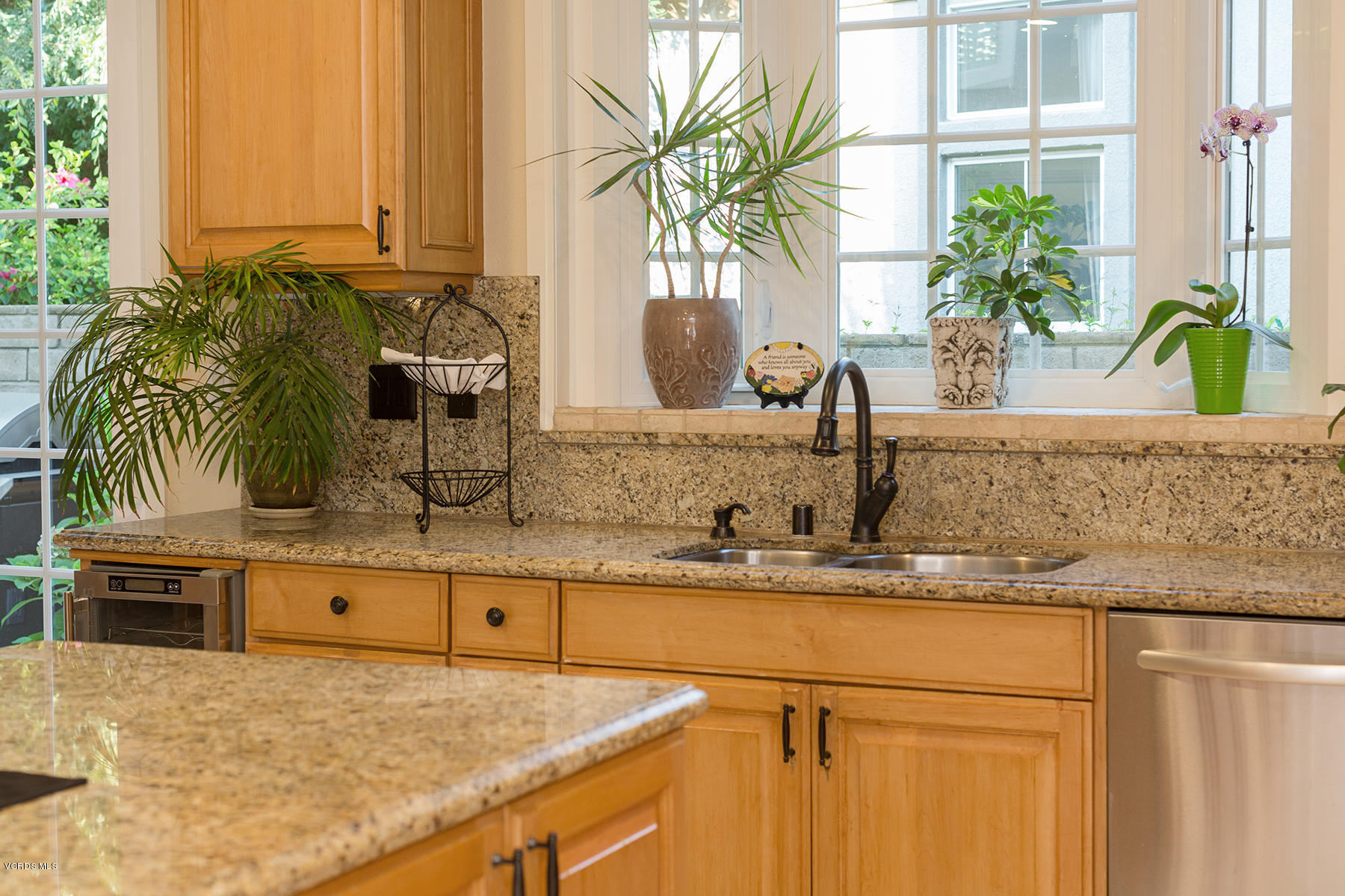 203 Knoll Ridge Road Simi Valley, CA 93065 - Photo 19 of 53 a kitchen with kitchen island granite countertop a sink a potted plant and a large window