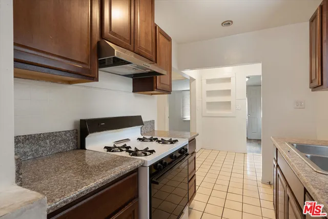 a kitchen with stainless steel appliances granite countertop a stove and a sink
