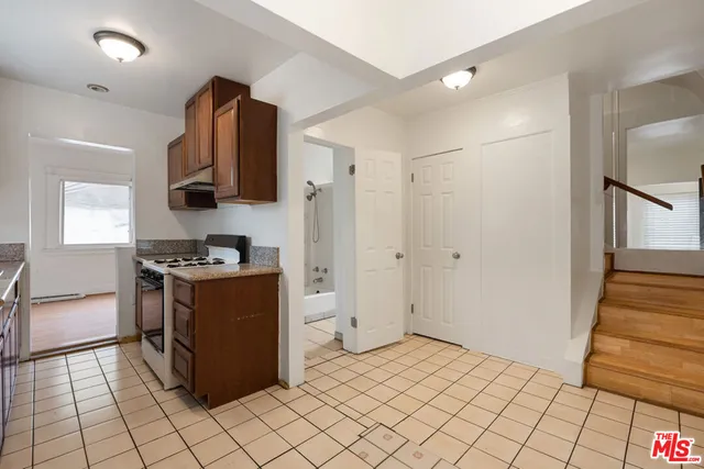 a kitchen with stainless steel appliances granite countertop a refrigerator and a stove
