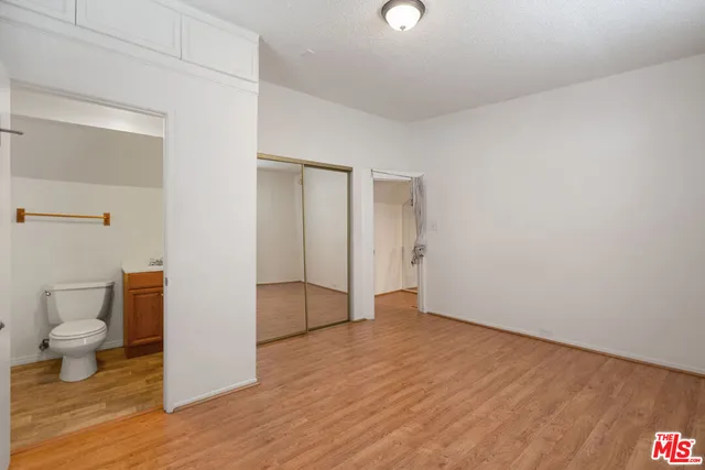 a view of an empty room and wooden floor
