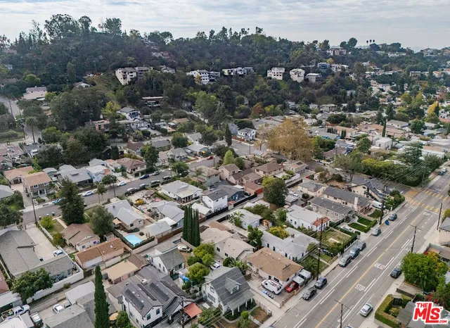 an aerial view of residential houses with outdoor space