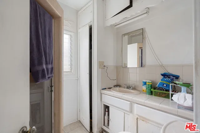 a bathroom with a sink a vanity and a mirror