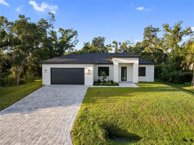 a kitchen with kitchen island granite countertop a stove and a sink with wooden floor
