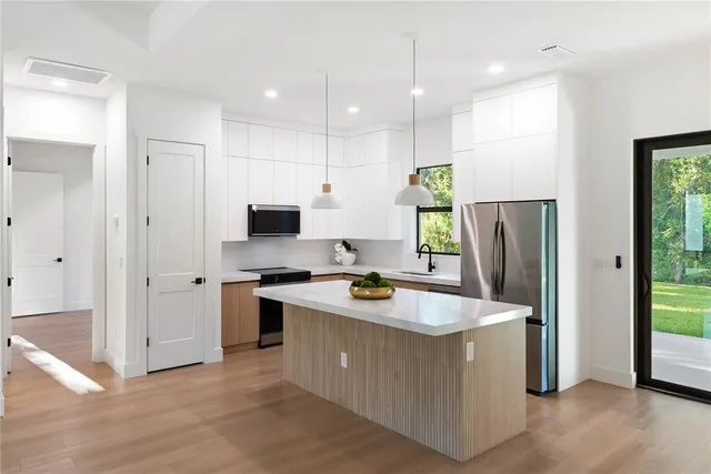 a view of a kitchen with a sink and a window