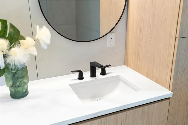 a kitchen with stainless steel appliances granite countertop a sink a stove a refrigerator and island with wooden floor