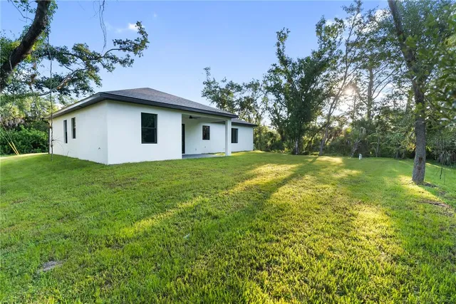 a view of an empty room with closet and a window