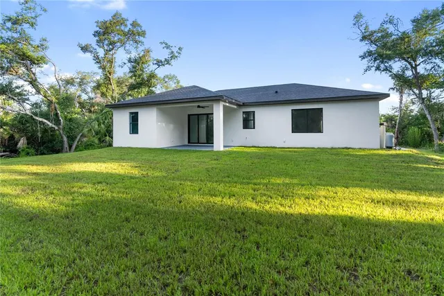 a bathroom with a tub a sink a window and mirror