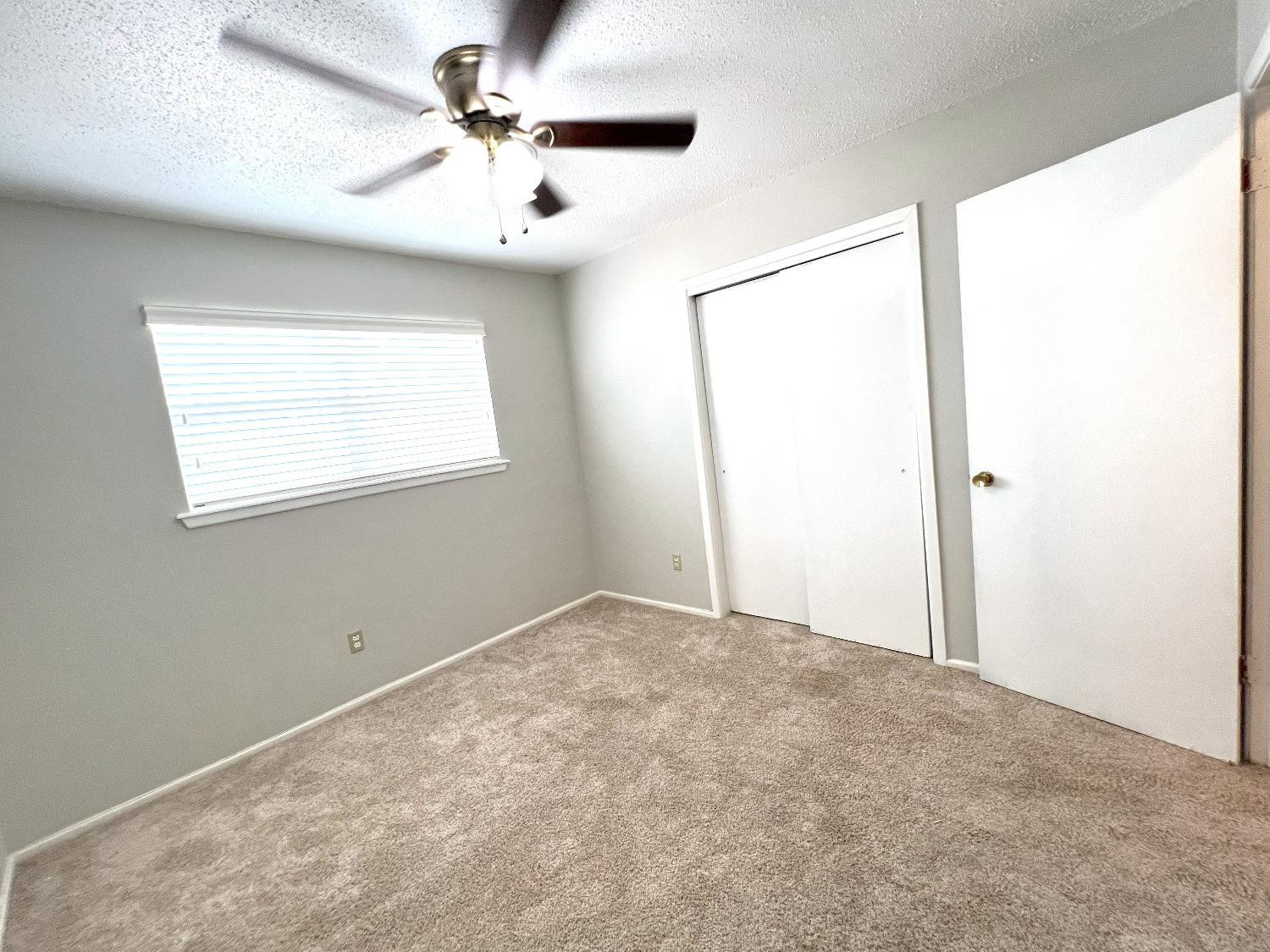 5540 18th Street Lubbock, TX 79416 - Photo 11 of 18 an empty room with windows and fan