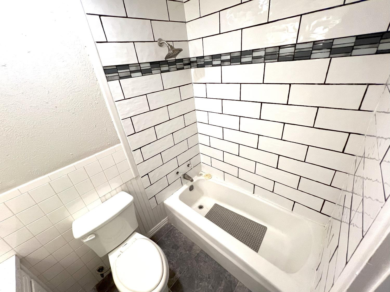 5540 18th Street Lubbock, TX 79416 - Photo 12 of 18 a bathroom with a bathtub and sink