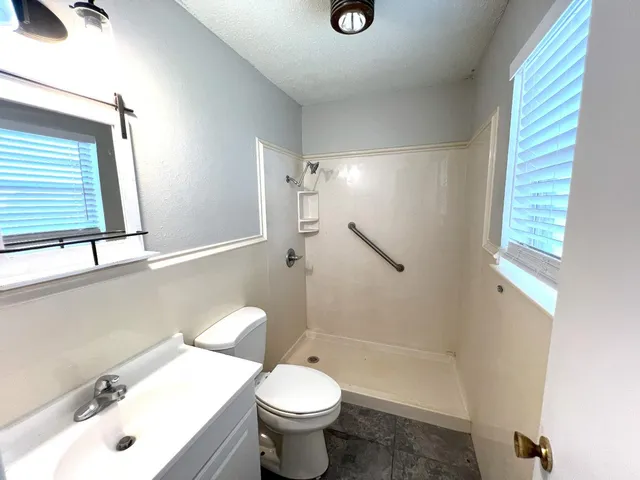 a bathroom with a sink toilet and shower