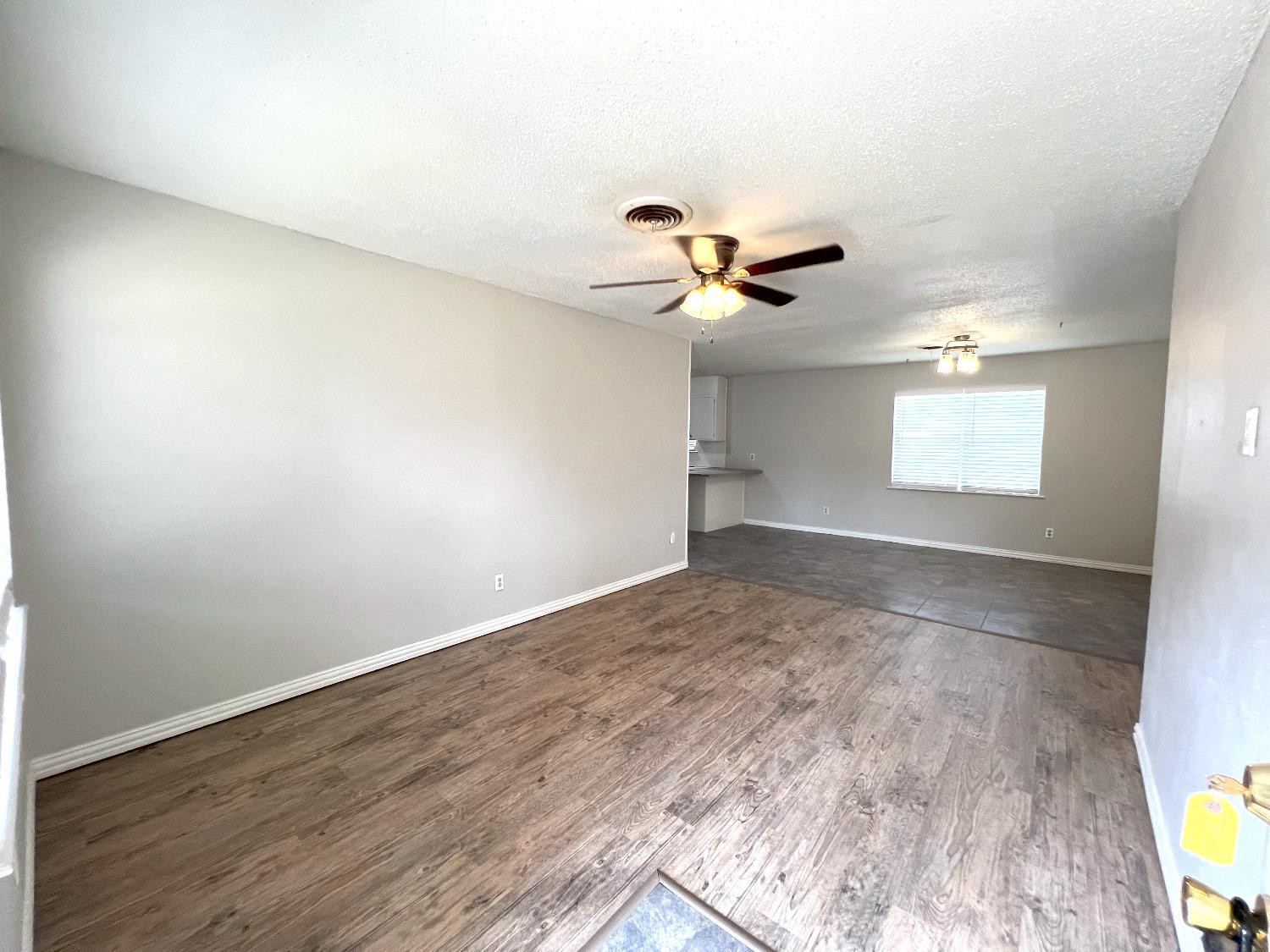 5540 18th Street Lubbock, TX 79416 - Photo 2 of 18 an empty room with a window and a ceiling fan