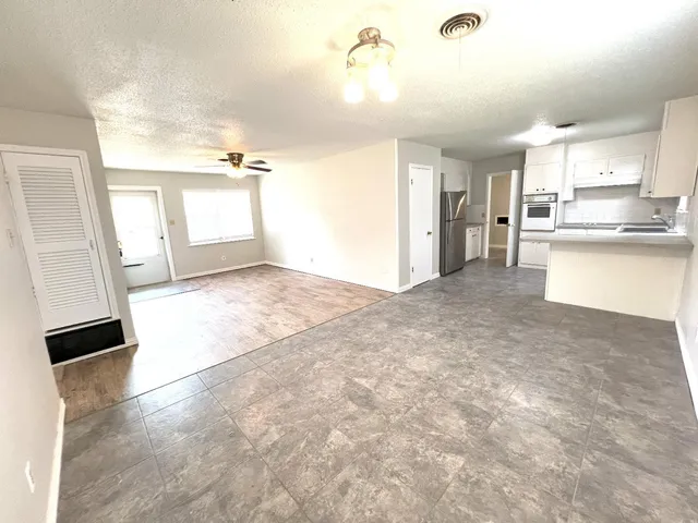 a view of a kitchen with a sink and dishwasher cabinets