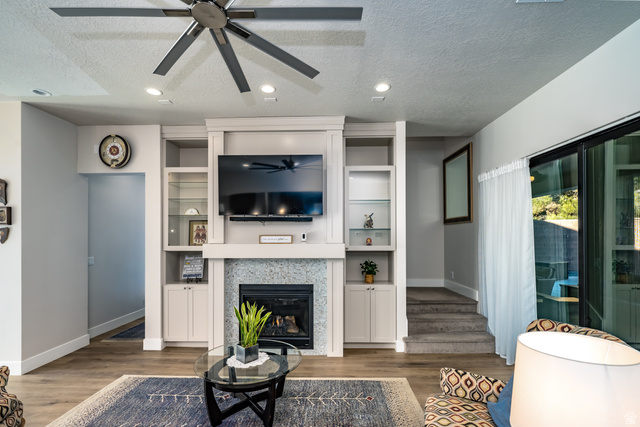 1283 North Gallen Road Santa Clara, UT 84765 - Photo 17 of 103 Living room with a textured ceiling, a ceiling fan, wood finished floors, a glass covered fireplace, and recessed lighting